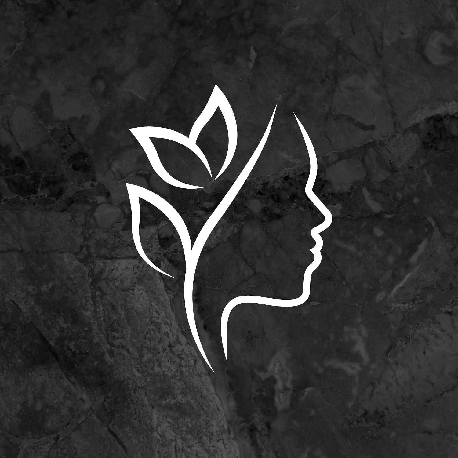 Silhouette of a woman's profile blended with leaf motifs on a dark marble background.
